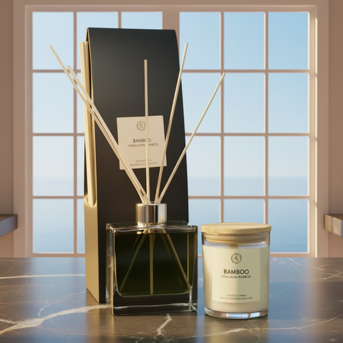 Bamboo diffuser and candle set with reeds on a marble counter.