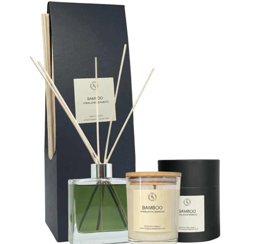 Set of bamboo-themed diffuser, candle, and reed sticks with packaging on a white background