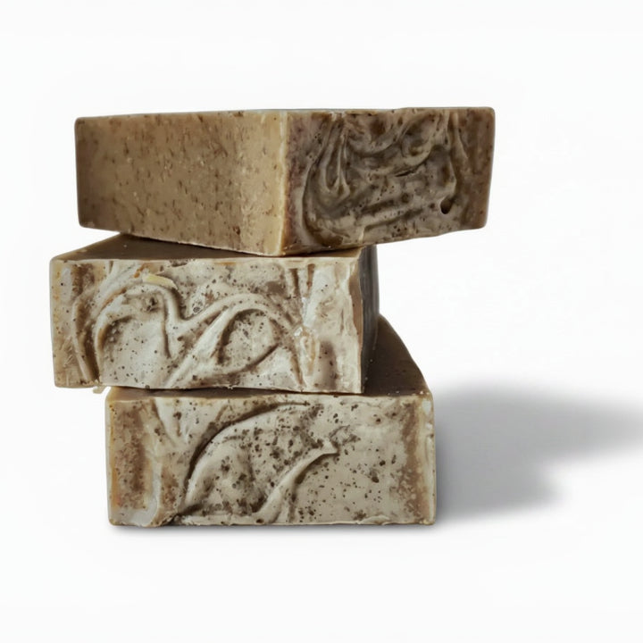 Three stacked soap bars with decorative patterns on a white background
