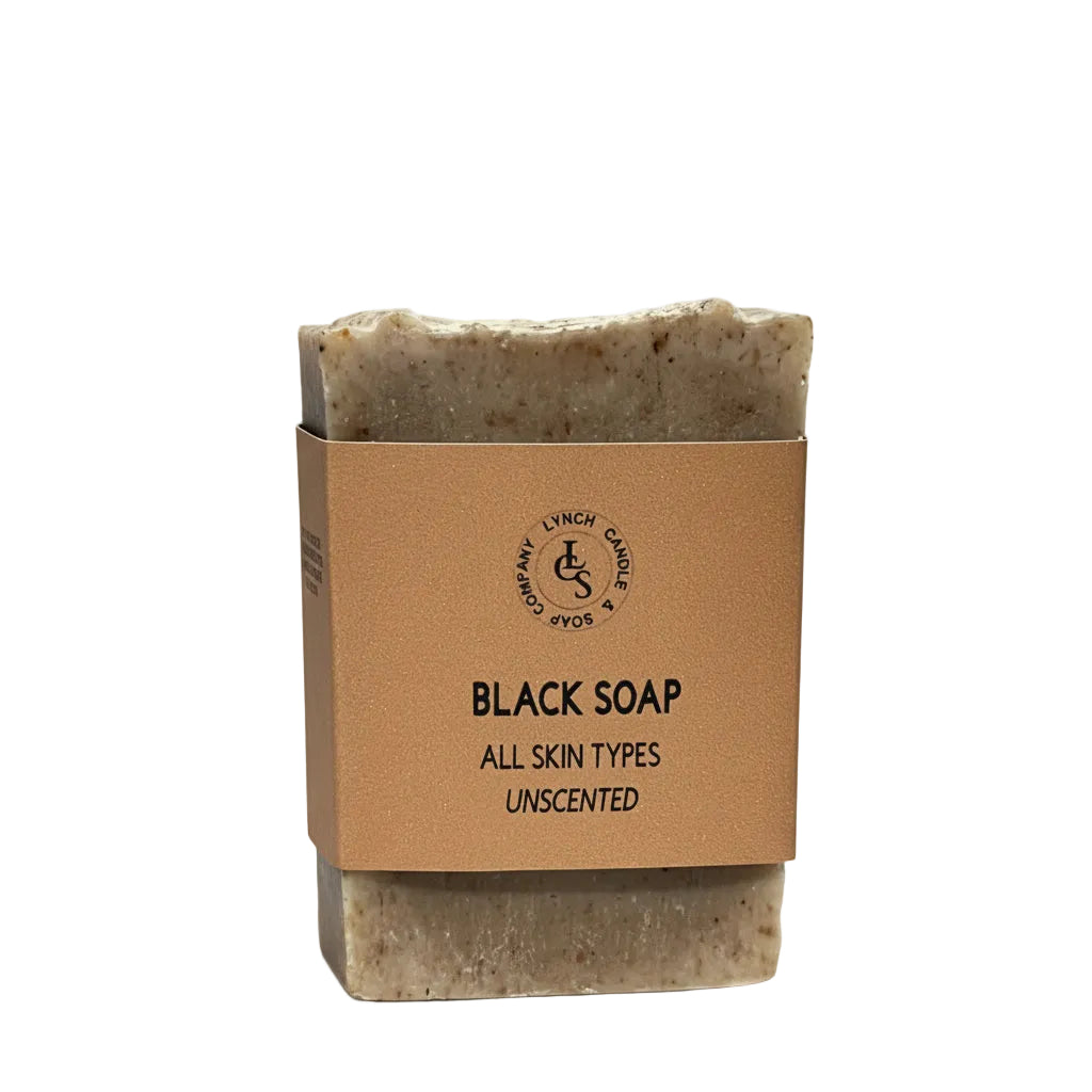 Bar of black soap with a brown cardboard packaging on a white background