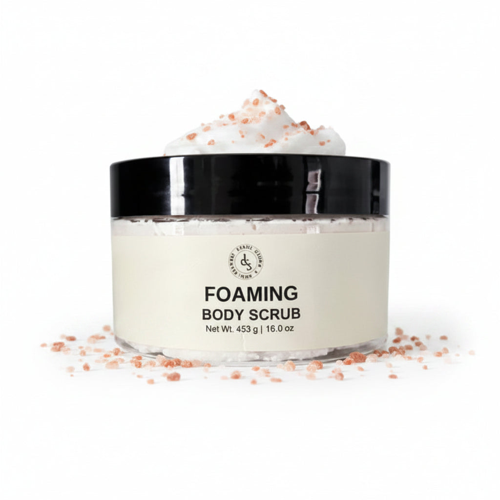 Jar of foaming body scrub with black lid on a white background