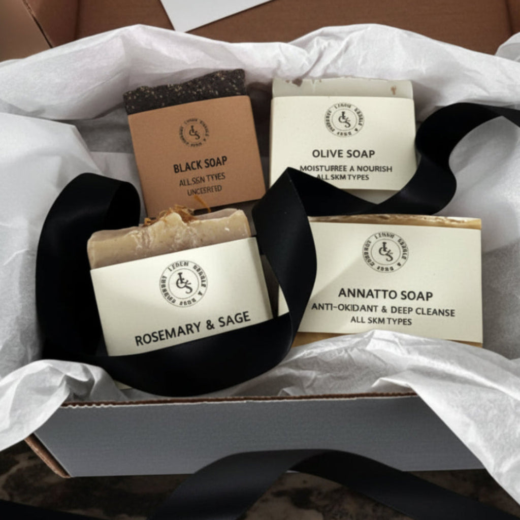 Four bars of soap with labels on a white tissue paper