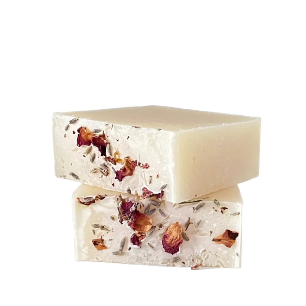 Two bars of soap with dried flowers on a light gray background
