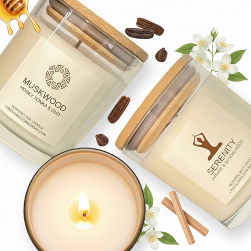 Three scented candles with wooden lids on a white background, featuring 'Muskwood' and 'Serenity' labels.
