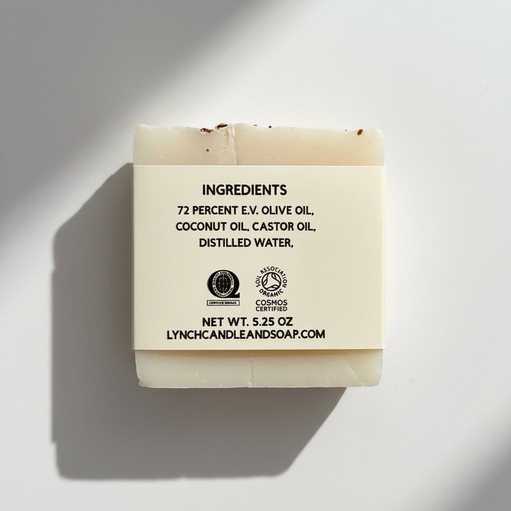 Bar of soap with a label detailing ingredients and certification on a white background