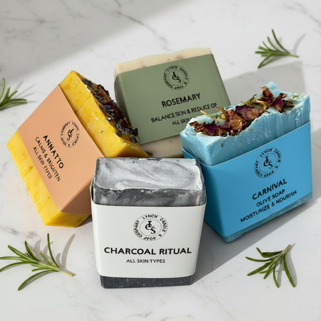 Four soaps with different scents and designs on a striped fabric background