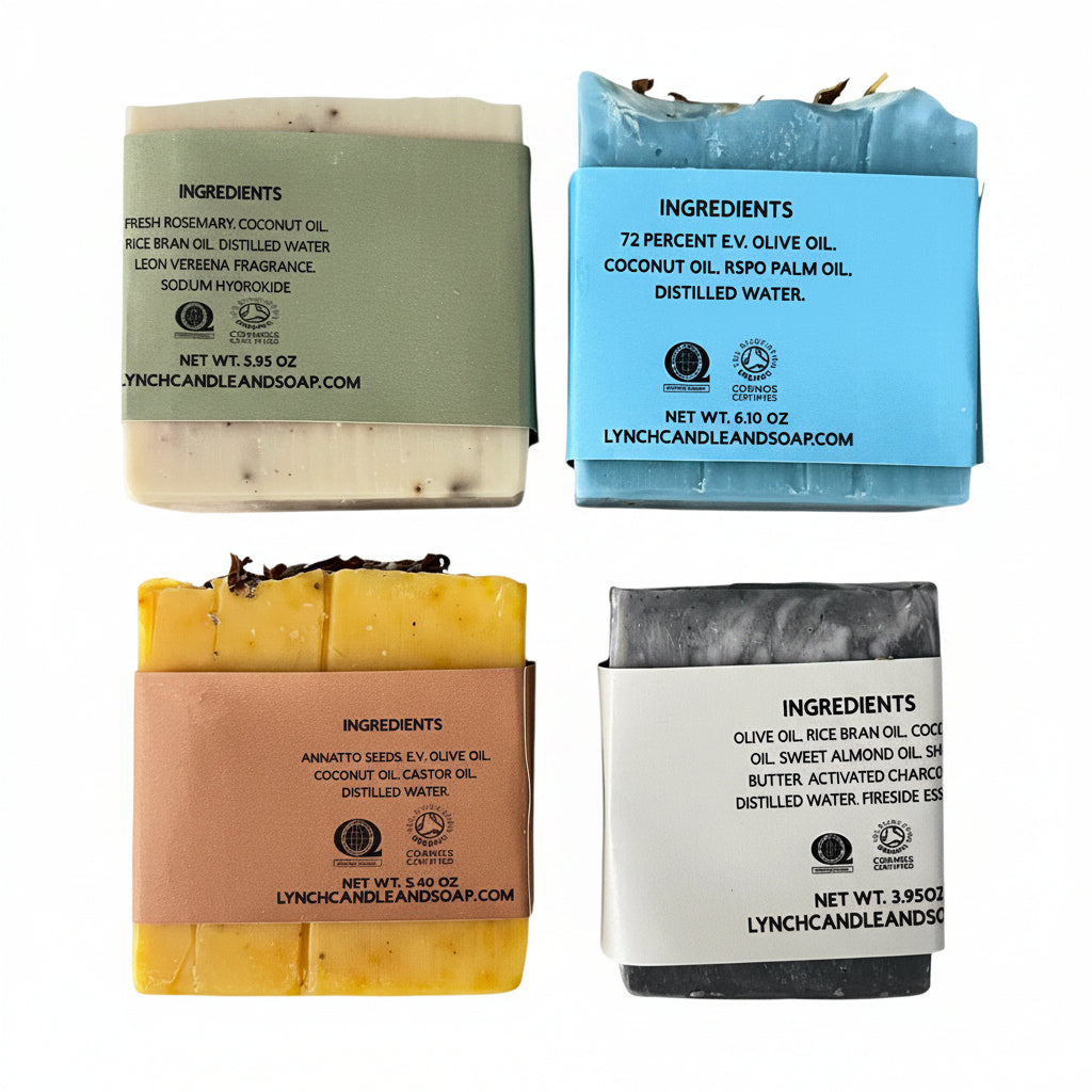 Four soap bars with visible labels on a striped fabric background