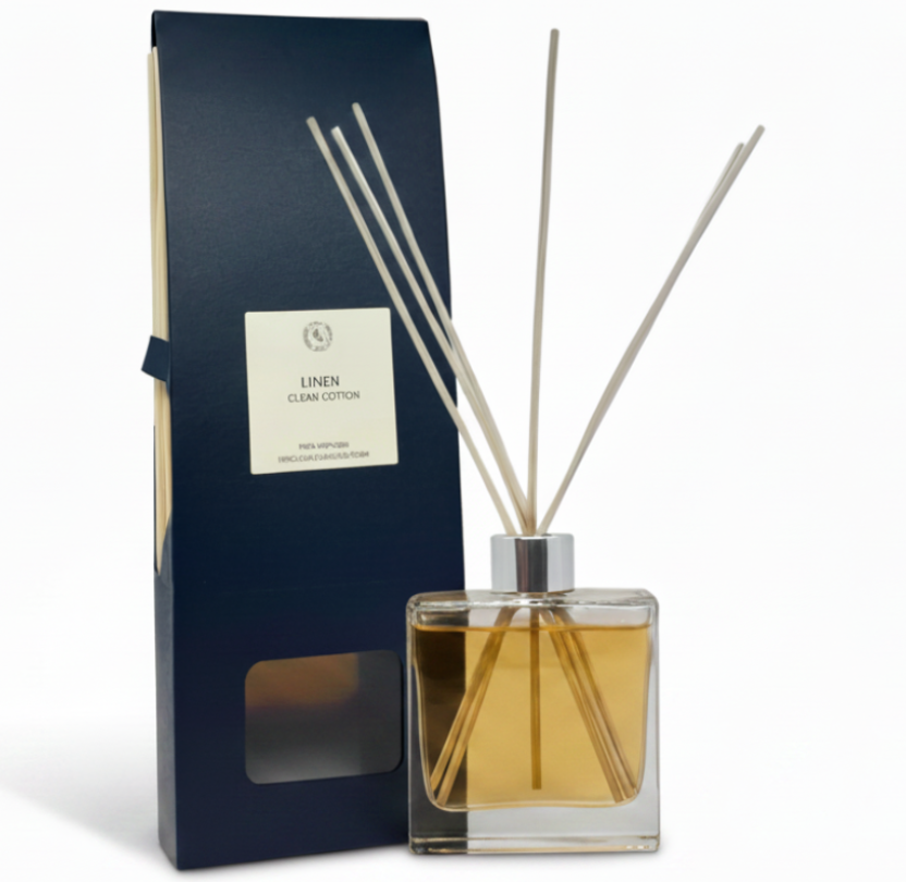 linen Reed diffuser set with packaging and cotton branches on a white background