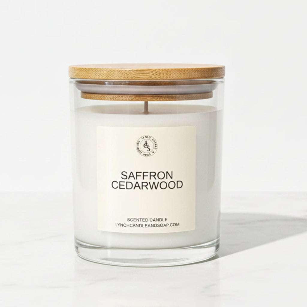 Saffron Cedarwood candle with a wooden lid on a gray surface.