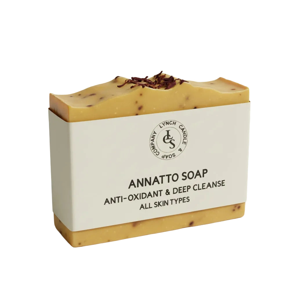Annatto soap bar with visible branding on a plain background